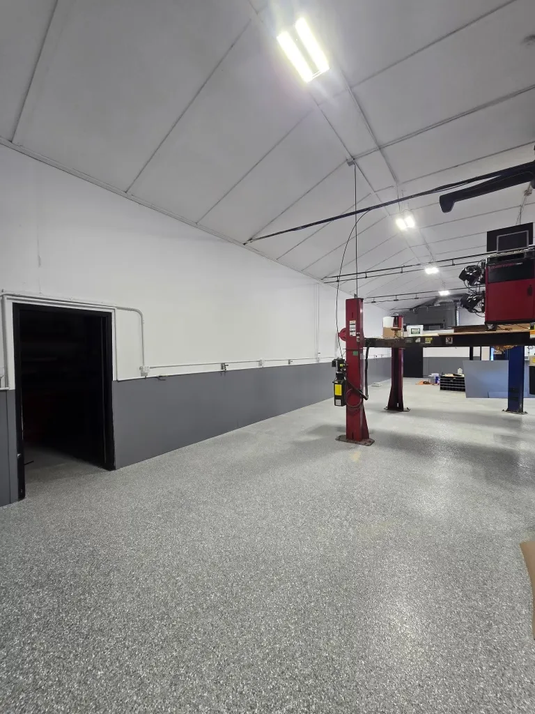 The same bay after the repaint, white walls above a clean gray wainscot
