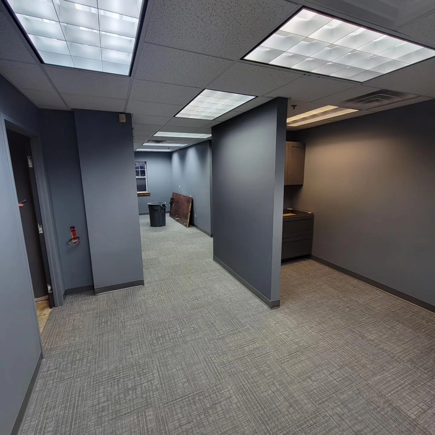 Finished commercial office in slate gray with carpet installed and the space ready for business